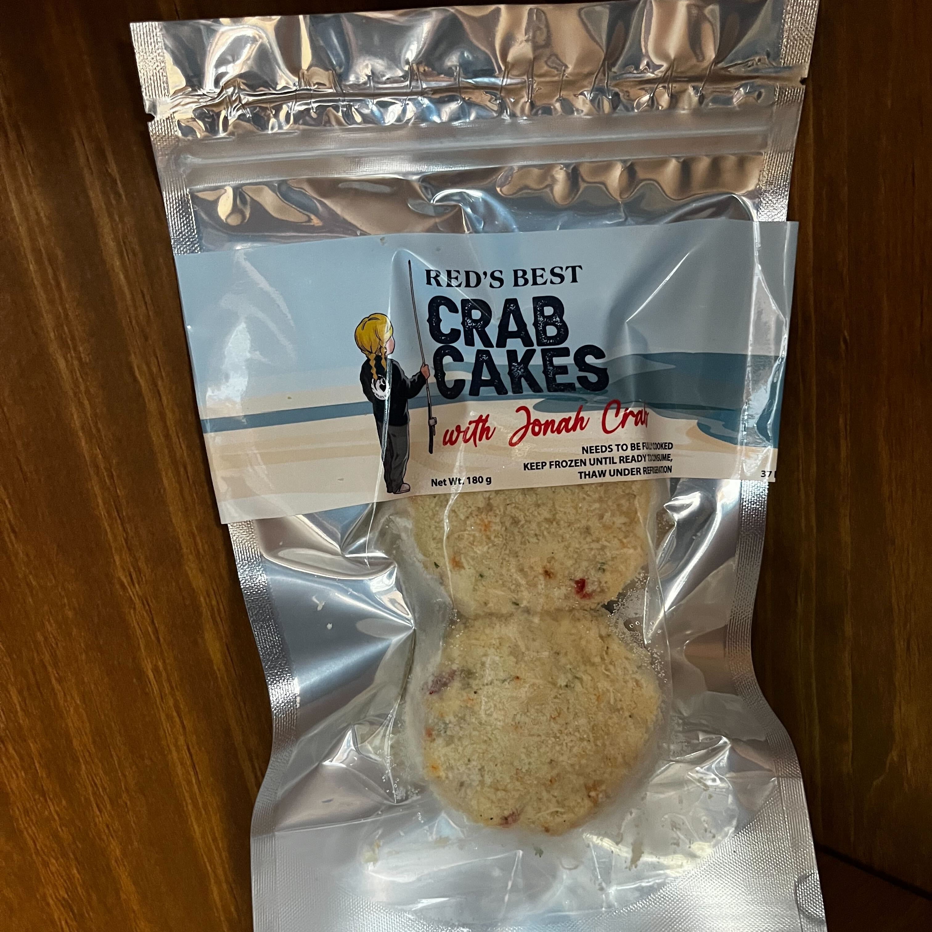 Packaged crab cakes with 'Red's Best Crab Cakes' label on a wooden surface