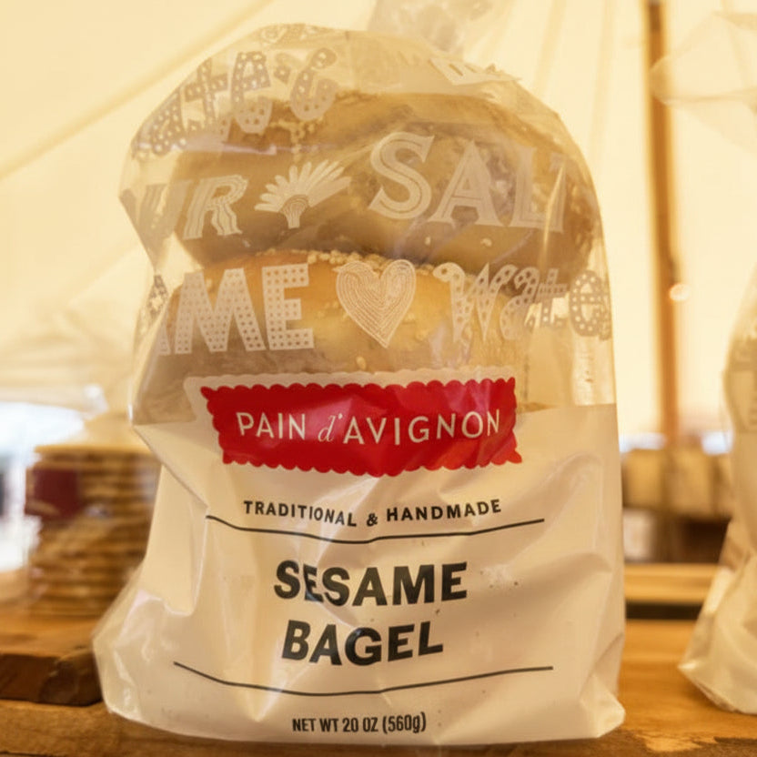 Bagel package with 'Pain d'Avignon' branding on a wooden surface.